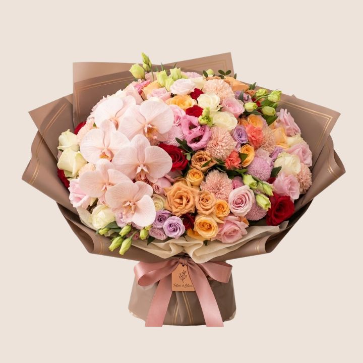 Orchid & Rose Luxury Bouquet 1 Handcrafted orchid and rose bouquet featuring vibrant blooms and lush greenery in a professional studio setting.